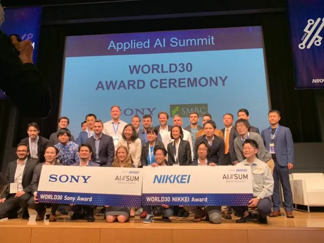 The Mujin team takes a photo with the World 30 NIKKEI award at the Applied AI Summit