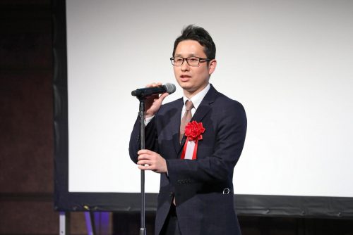 Mujin co-founder Issei Takino speaks on-stage