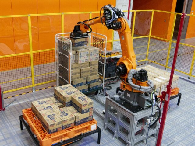 An orange palletizing robot demonstrates the ability to create a full pallet load