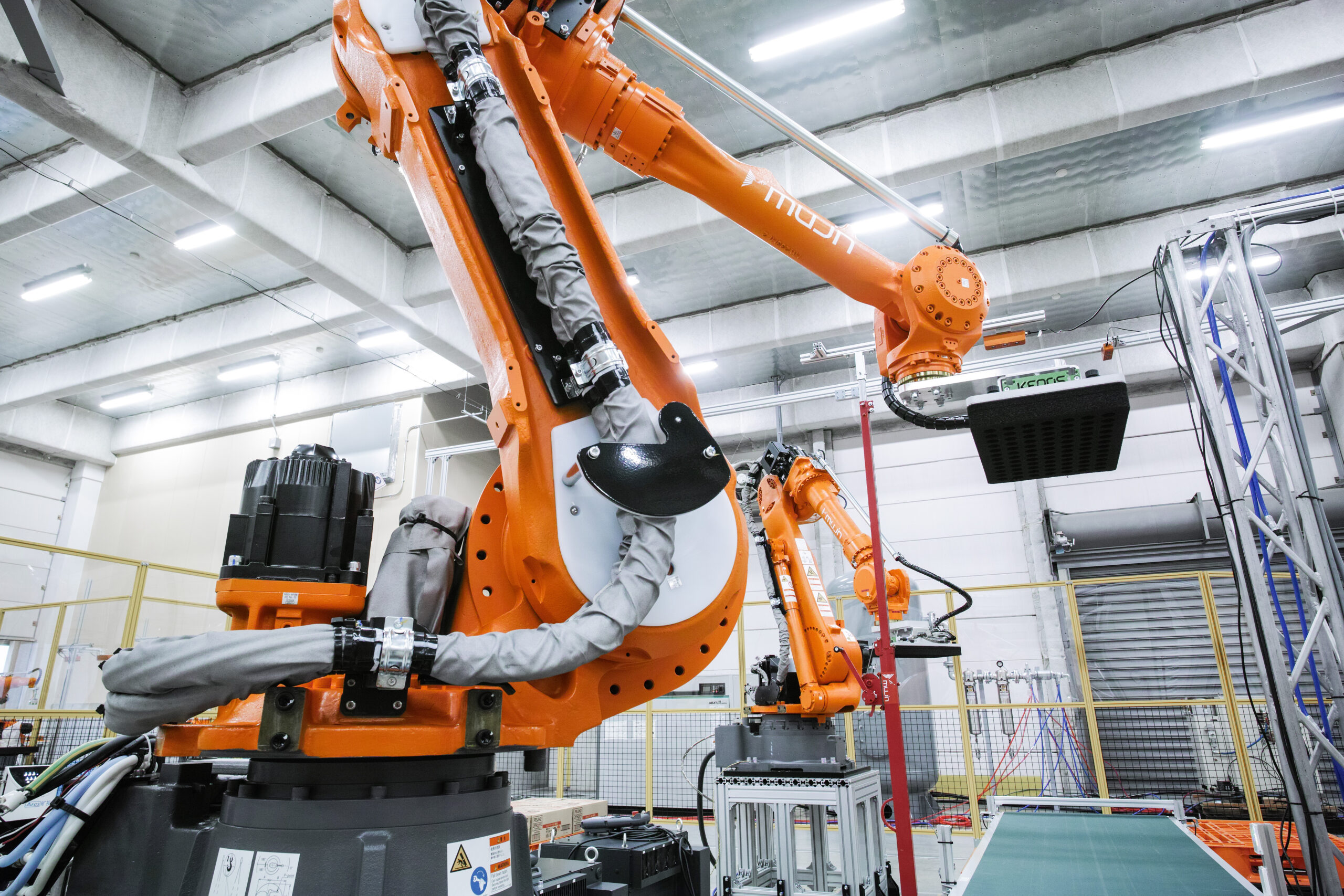 Underneath view of an orange Mujin palletizing robot