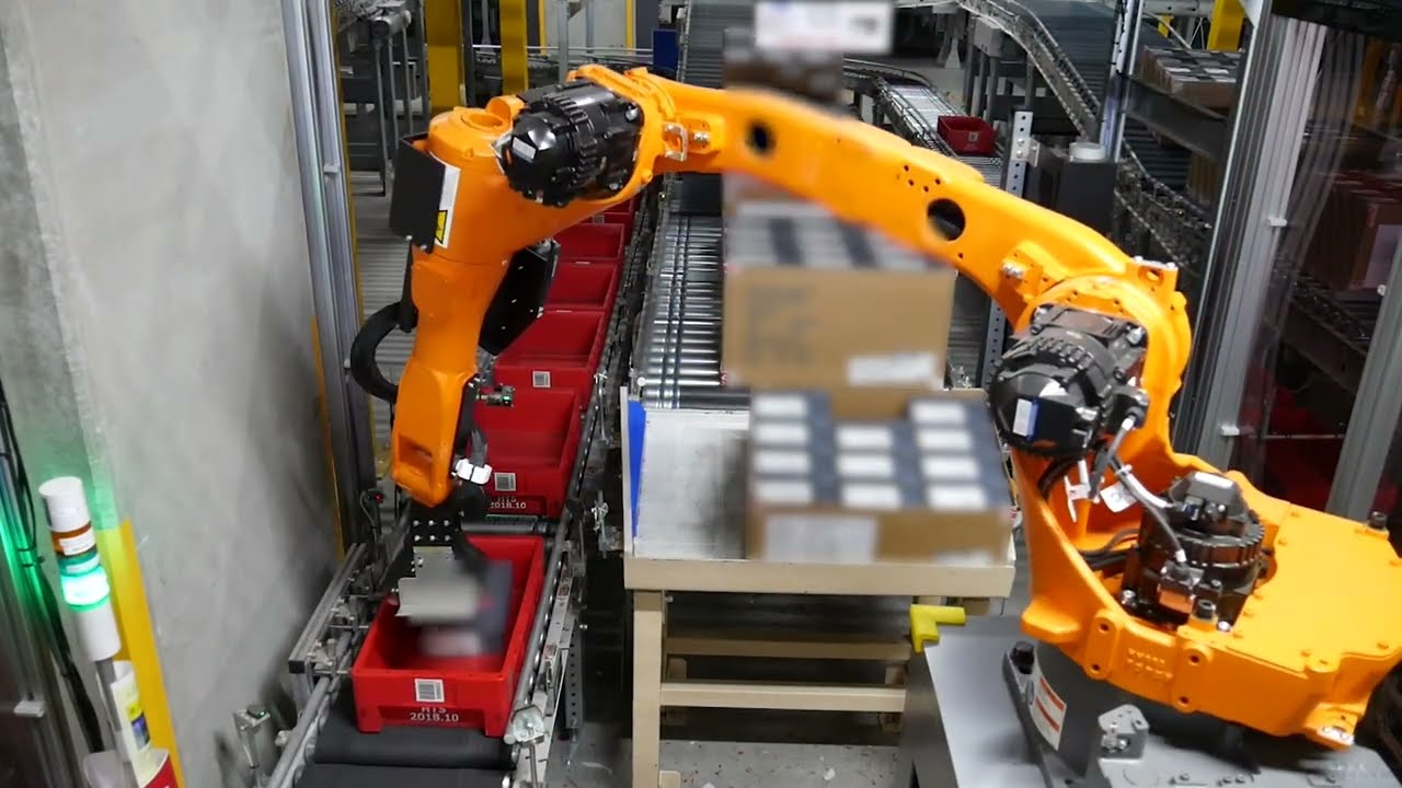 Close-up of the Hitachi robotic piece picking robot placing a package into a bin